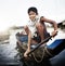 Boy Traveling by Boat in Floating Village Concept