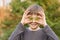 The boy tries on the eye bitcoin coin in the summer in the Park.