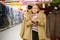 Boy tries on jacket in shop