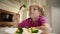 Boy tries to eat a vegetables but dosen`t like it and rejects the food. Healthy food concept. Children and vegetables.