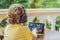 Boy in tropics talking with friends and family on video call using a tablet and wireless headphones