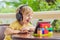 Boy in tropics talking with friends and family on video call using a tablet and wireless headphones