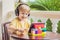 Boy in tropics talking with friends and family on video call using a tablet and wireless headphones