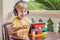 Boy in tropics talking with friends and family on video call using a tablet and wireless headphones