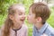 Boy trying kissing cheerful girl