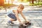 The boy is trying to jump on a skate and ride on it