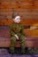 A boy in uniform against the background of wooden boards