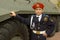 Boy in uniform with an armored troop carrier