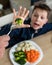 Boy unsatisfied with vegetable lunch