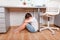 Boy upset. Teenage boy sit alone under desk, covering his face