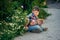 A boy uses a smartphone on a street walk