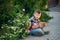 A boy uses a smartphone on a street walk