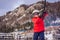 Boy uses a training lift. Child skiing in mountains. Active toddler kid with safety helmet, goggles and poles. Ski race