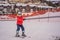 Boy uses a training lift. Child skiing in mountains. Active toddler kid with safety helmet, goggles and poles. Ski race