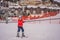 Boy uses a training lift. Child skiing in mountains. Active toddler kid with safety helmet, goggles and poles. Ski race