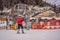 Boy uses a training lift. Child skiing in mountains. Active toddler kid with safety helmet, goggles and poles. Ski race