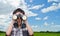 Boy using binoculars in field