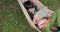 Boy using digital tablet while lying on hammock