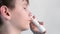 Boy using nasal spray and smiling