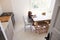 Boy using tablet in kitchen, elevated view from doorway