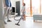 Boy vacuuming floor while father standing