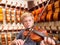 Boy Violinist Playing A Violin In A Music Store