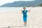 Boy is waking and playing on the beach. Summer holidays