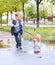Boy walk with pet through the puddle after spring rain