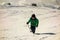 Boy with walking poles on a path in the mountains