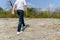 Boy walking on the rocky land.