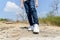 Boy walking on the rocky land.