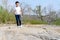 Boy walking on the rocky land.