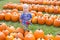 Boy Walking Between Rows of Large Pumpkins