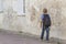 Boy walking in the street with his backpack. Back view. People education, school, travel, leisure concept