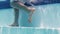 Boy walking underwater on steps in swimming pool