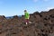 Boy walking in volcanic area