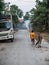Boy walks the ox people burn waste on street