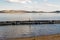 A boy walks on a pontoon on a lake