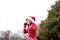 A boy in a warm Christmas sweater with a New Year`s deer and a Santa hat conducts a workout boxing sparky in the fresh air