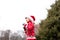 A boy in a warm Christmas sweater with a New Year`s deer and a Santa hat conducts a workout boxing sparky in the fresh air