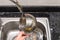 Boy washing dishware in the kitchen sink