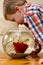 Boy watching fish in bowl