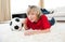 Boy watching football match lying on the floor