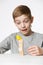 Boy watching house made of wooden blocks fall