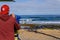 Boy Watching From A Spyglass Group of boys and girls at sunrise entering the Ocean to start a surfing class at Playa de Las