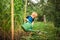 A boy watering flowers and a vegetable garden with a watering can. The boy helps with the summer garden. Children`s games with wat