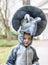 Boy wearing dinosaur costume