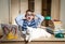 Boy Wearing Funny Glasses Doing Homework With Cat Sitting On The Desk. Child With Learning Difficulties. Boy Having Problems With