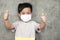 A boy wearing medical face mask for pollution or coronavirus,child itchy eyes and nose.