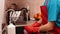 Boy wearing rubber gloves washing a glass